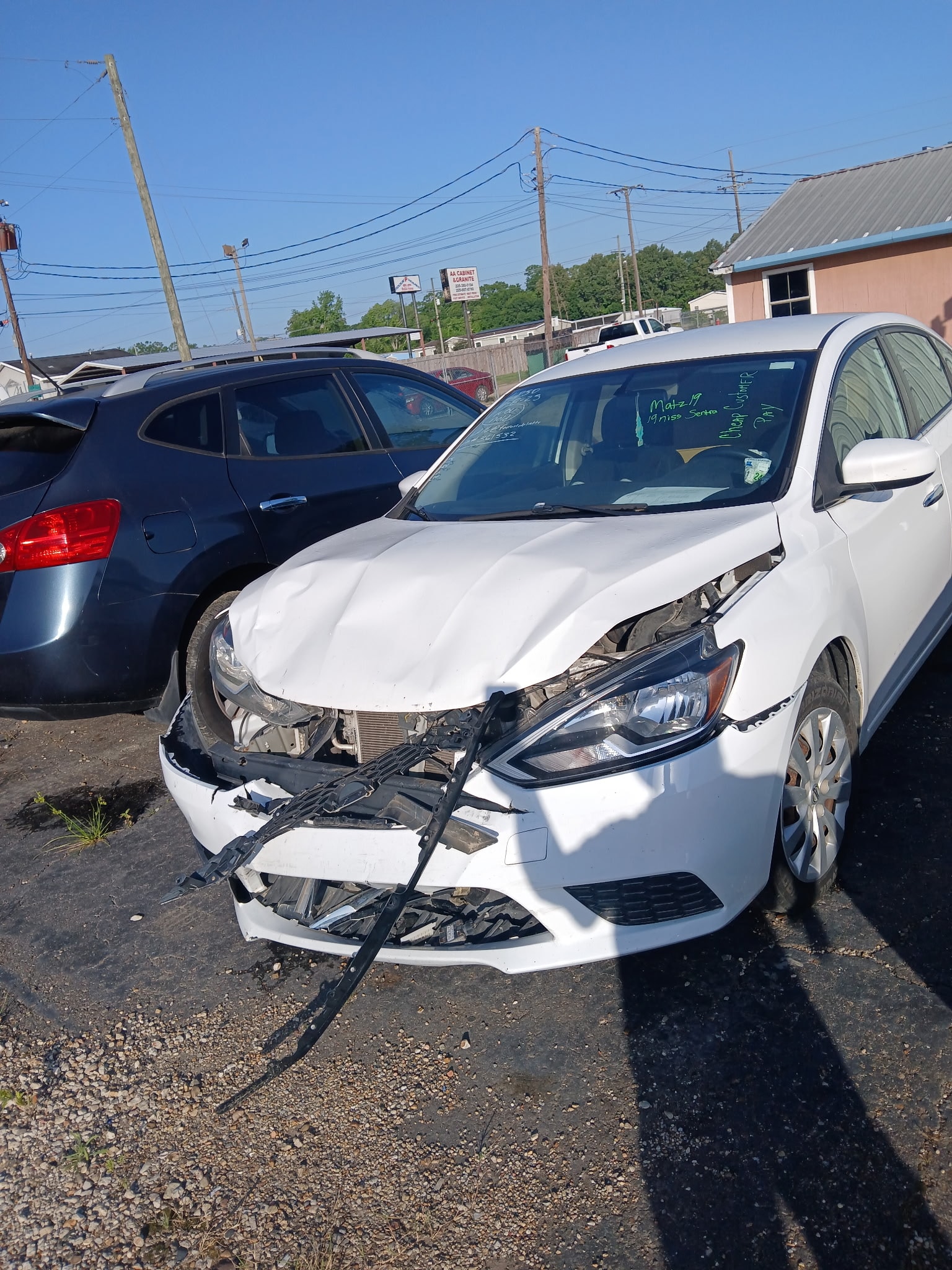 White Nissan Sentra before collision repair
