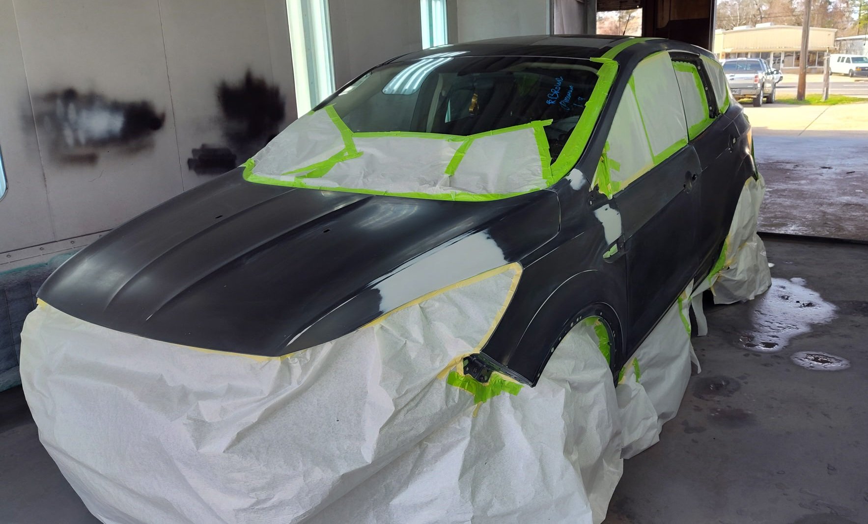 Vehicle masked and prepped for paint job at Expert Collision LLC
